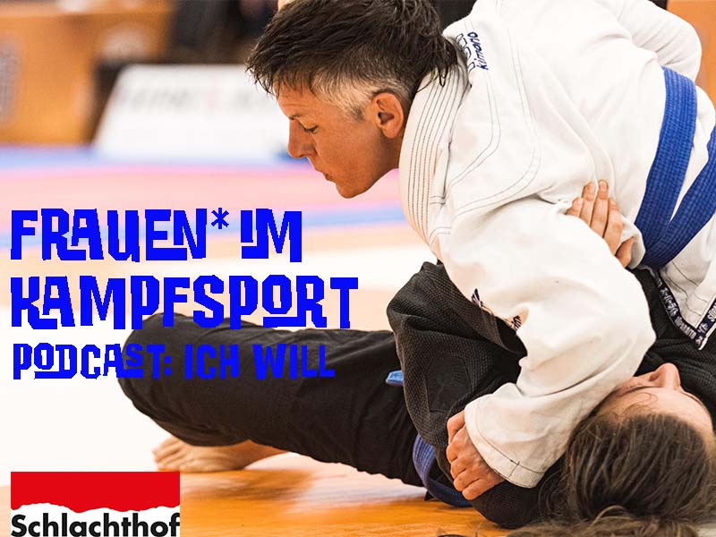 Two women in white judo suits fight on a hall floor.